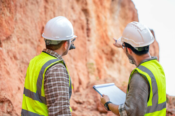 Obraz premium Expert geologists are analyzing layers of rocks that have been deposited for a long time to learn about past organisms and plants.