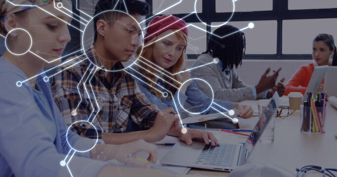 Image of network of connections over diverse female and male coworkers - Powered by Adobe