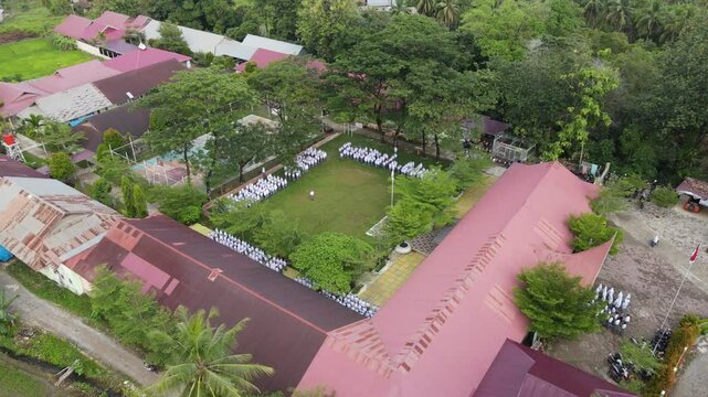 Aerial Drone View of Senior High School Students Performing Upacara Bendera (Flag Ceremony) Outdoors in Padang, Indonesia