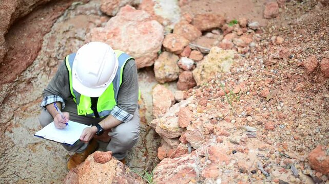 A geologist is examining the soil layers in a valley.