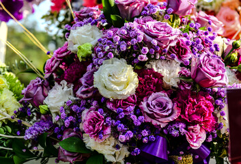 Beautiful flowers bouquet in different color tone and styles in Thailand market, nice background textures. Thai orchids, roses, carnations etc. Close up shot.