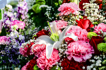 Beautiful flowers bouquet in different color tone and styles in Thailand market, nice background textures. Thai orchids, roses, carnations etc. Close up shot.