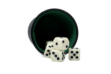 A dice cup has spilled, scattering several white dice with black spots across a white surface.