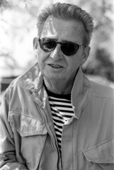 Grainy analog portrait of senior man wearing sunglasses