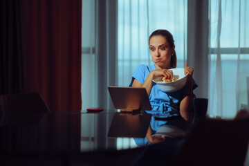Woman Eating Popcorn and Watching a Series on her Tablet. Person watching a suspenseful movie and waiting to see how it ends
