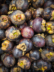 A close-up view shows a pile of fresh mangosteens, a popular tropical fruit in Jakarta, Indonesia.
