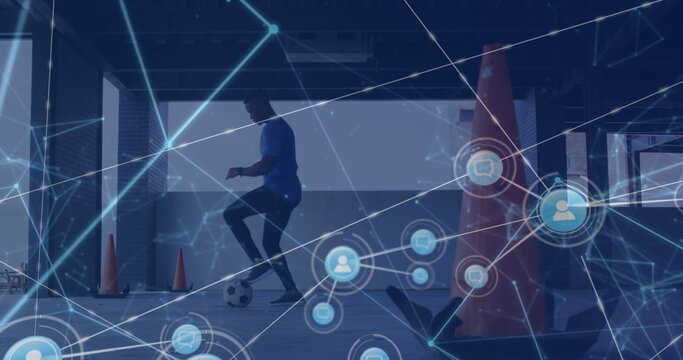 Network of digital icons against african american male soccer player practicing - Powered by Adobe