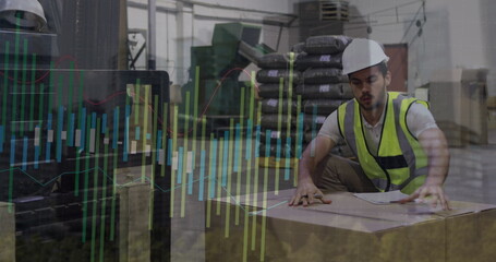 Image of male warehouse worker over graphs