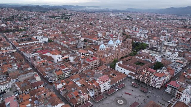 4K 60fps drone shot of Cuenca, Ecuador, featuring the iconic Catedral de la Inmaculada Concepci&oacute;n at the center. A panoramic view of the entire city surrounded by the Andes mountains.