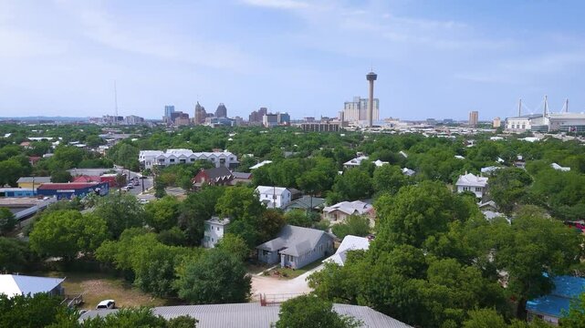 Landscape drone shot of the city of San Antonio downtown that includes the famous Alamodome, the Hemisfair Tower of Americas and the city's skyline from the South side of town.