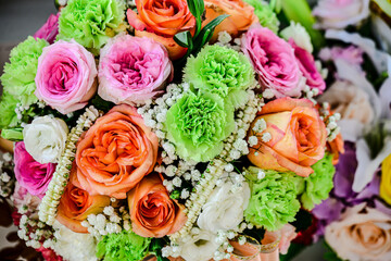 Beautiful flowers bouquet in different color tone and styles in Thailand market, nice background textures. Thai orchids, roses, carnations etc. Close up shot.