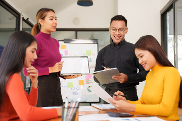 Group of Asian business people working together in an office