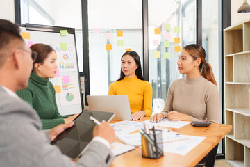 Group of Asian business people working together in an office