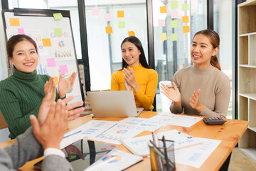Group of Asian business people working together in an office