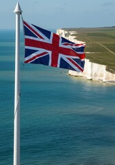 Waving UK Union Jack Flag Symbolizing Island Nation History Against the Iconic White Cliffs of Dover
