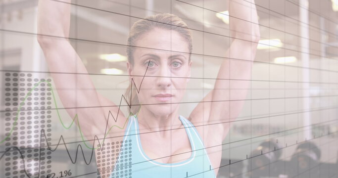 Fototapeta Image of statistical data processing over caucasian fit woman working out with dumbbells at gym