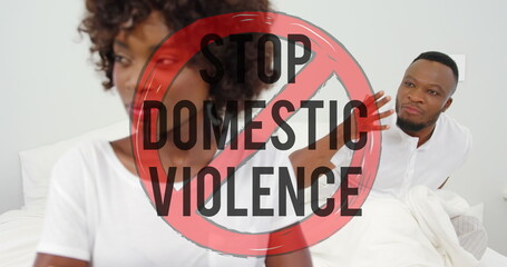 Image of stop domestic violence text over african american couple arguing