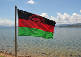 Waving Malawian Flag Symbolizing Warm Heart of Africa Over the Vast Expanse of Lake Malawi