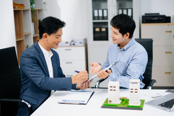 Signing a contract. Client and broker agent, lease agreement, successful deal and  Young business sitting at the desk