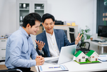 Obraz premium Real Estate Business Deal with Asian Salesmen and House Model