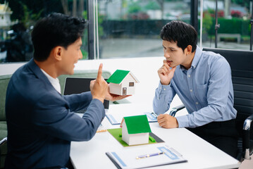 Real Estate Business Deal with Asian Salesmen and House Model