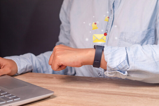 A business woman gets a notification message on her smart watch