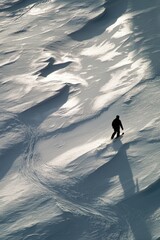 Snowboarder carving down snowy slopes mountain range aerial view winter sports dynamic landscape adventure
