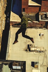 Parkour athlete leaping across rooftops urban setting aerial action shot dynamic view thrill and adventure