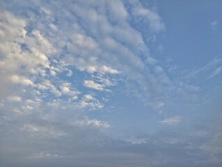 	
Bright blue sky with scattered clouds in the morning, summer sky landscape	
