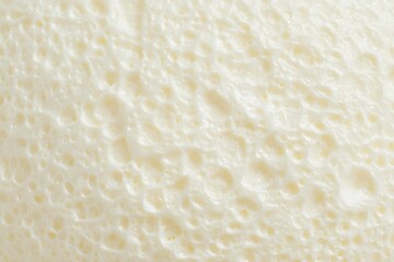 Close-up macro texture of a fresh, soft, and delicious bread. The image captures the intricate details of the bread's surface, offering a sensory experience of its softness and taste