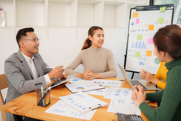 Group of Asian business people working together in an office