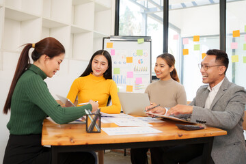 Group of Asian business people working together in an office