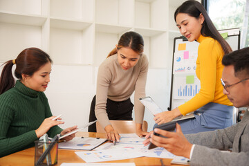 Group of Asian business people working together in an office