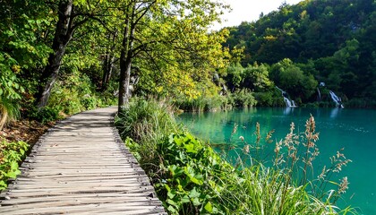 Wooden pathway beside a clear turquoise lake.
