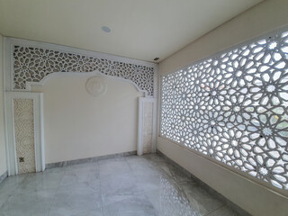 Abstract arabic Islamic patterns ornament on mosque wall. ventilation holes for smooth air circulationIslamic ornament carvings inside the mosque