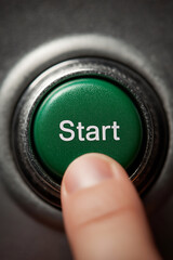Finger pressing a start button with the text "Start" and green light, Pushing power button. Technology, Energy and Innovation
