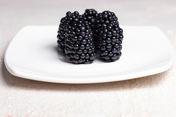 Minimalist Close-Up of Fresh Blackberries on White Plate