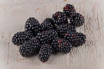 Fresh Ripe Blackberries on rustic light wooden background - macro close-up