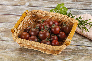 Obraz premium Juicy ripe black cherry tomato