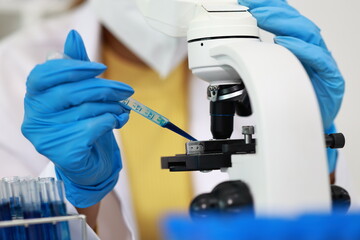Scientist in laboratory conducting research with advanced equipment, analyzing samples with...