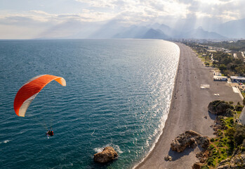 Aerial view of a paraglider in flight over Konyaalti Beach Antalya