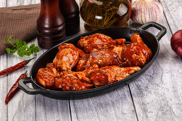 Raw marinated buffalo chicken wings