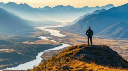 Person Standing on Mountain Overlooking River and Valley Landscape