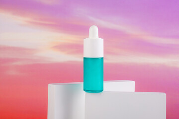 Blue glass cosmetic bottle, Skin care or sunscreen cosmetic on colorful background.