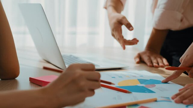 Startup company employee work together, compare analyze BI dashboard on paper and laptop with financial data report and planning strategic, marketing for business success in panorama video. Synergic