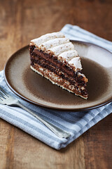 Piece of chocolate cake on rustic background. Close up.