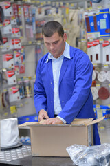 worker packing order into cardboard box