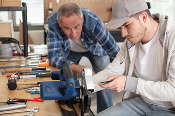 young apprentice in vocational training working with teacher
