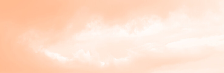 background of peach fuzz sky with the white cloud fluffy. peach fuzz colored trend color