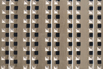 Perfect geometry of shadows and umbrellas on a deserted beach seen from above